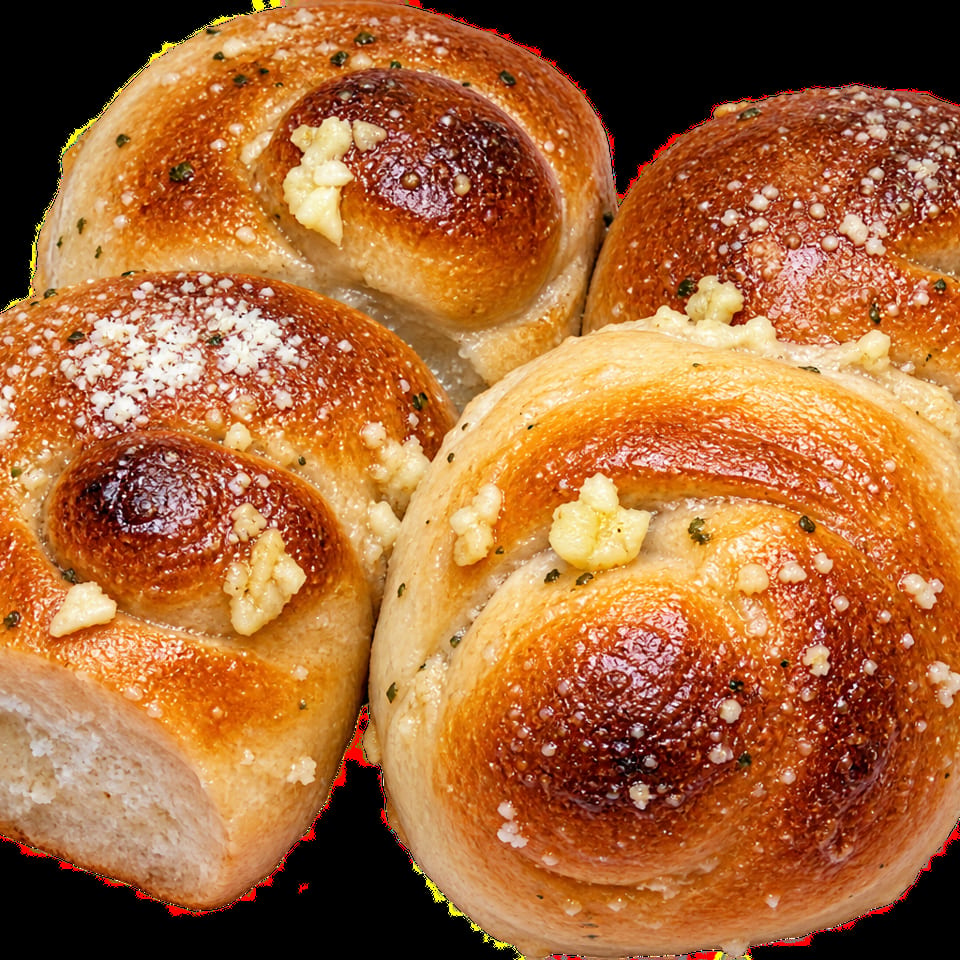 Four golden-brown spiral rolls topped with garlic butter, herbs, and grated cheese.